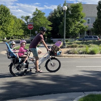 Molly's husband with kids on an e-bike