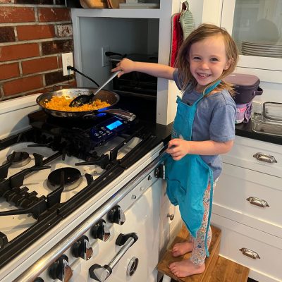 Lauren's daughter cooking on a portable induction cooktop